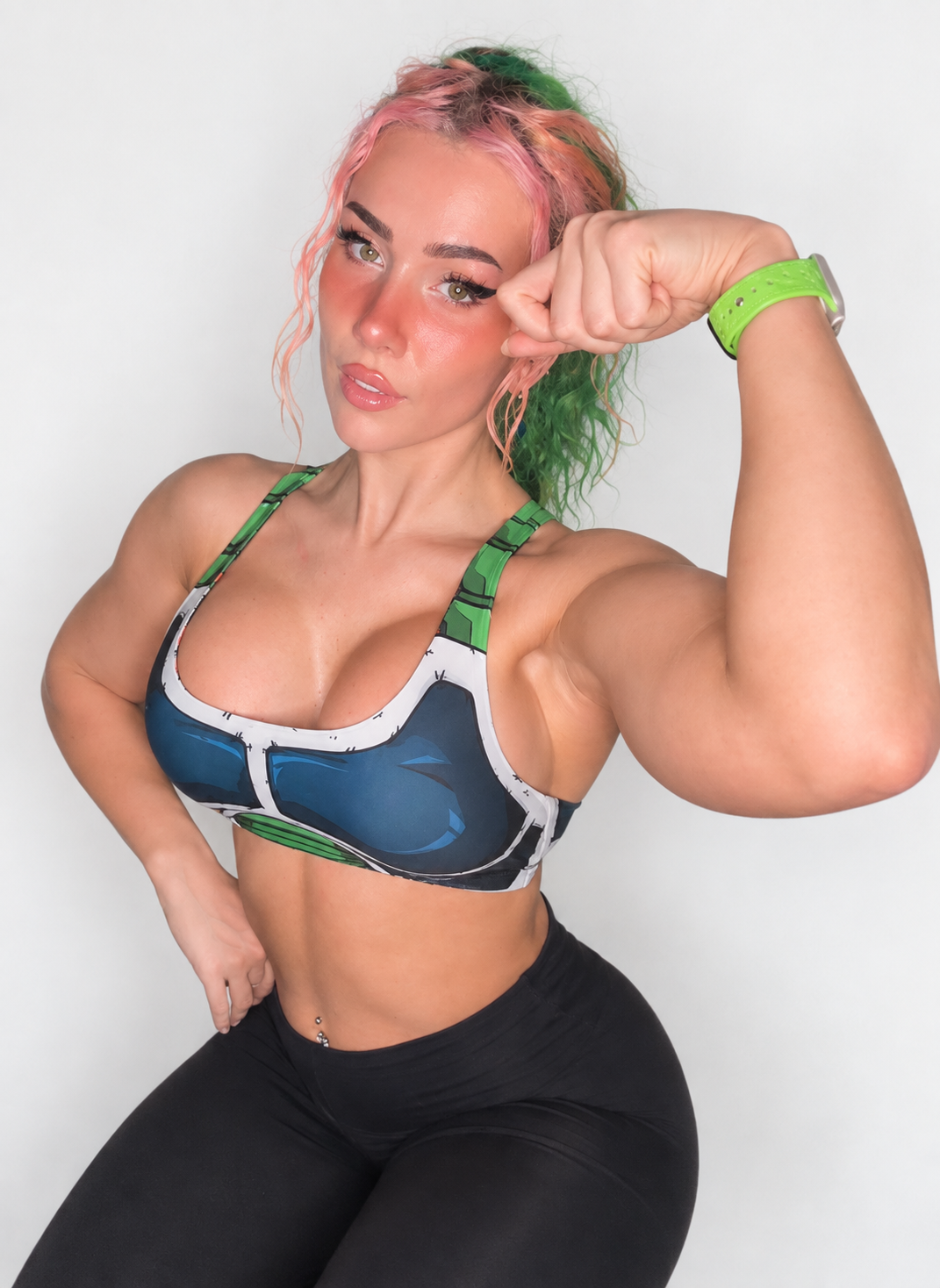 Kale with pink and green hair wearing an anime-inspired athletic top.